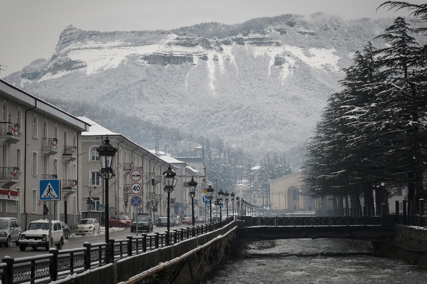 Tkibuli In Winter tkibuli town road river snow winter overcast clouds mountains landscape scenery travel outdoors georgia sakartvelo chizh
