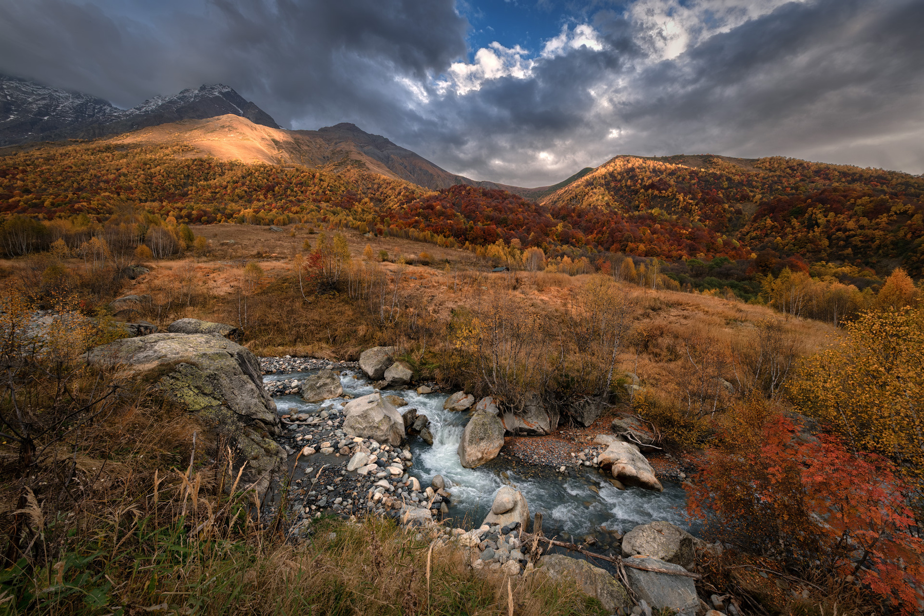 Fall In Koruldashi racha lechkhumi koruldashi river fall autumn forest trees yellow red mountains rocks clouds sky nature landscape scenery travel outdoors georgia sakartvelo chizh