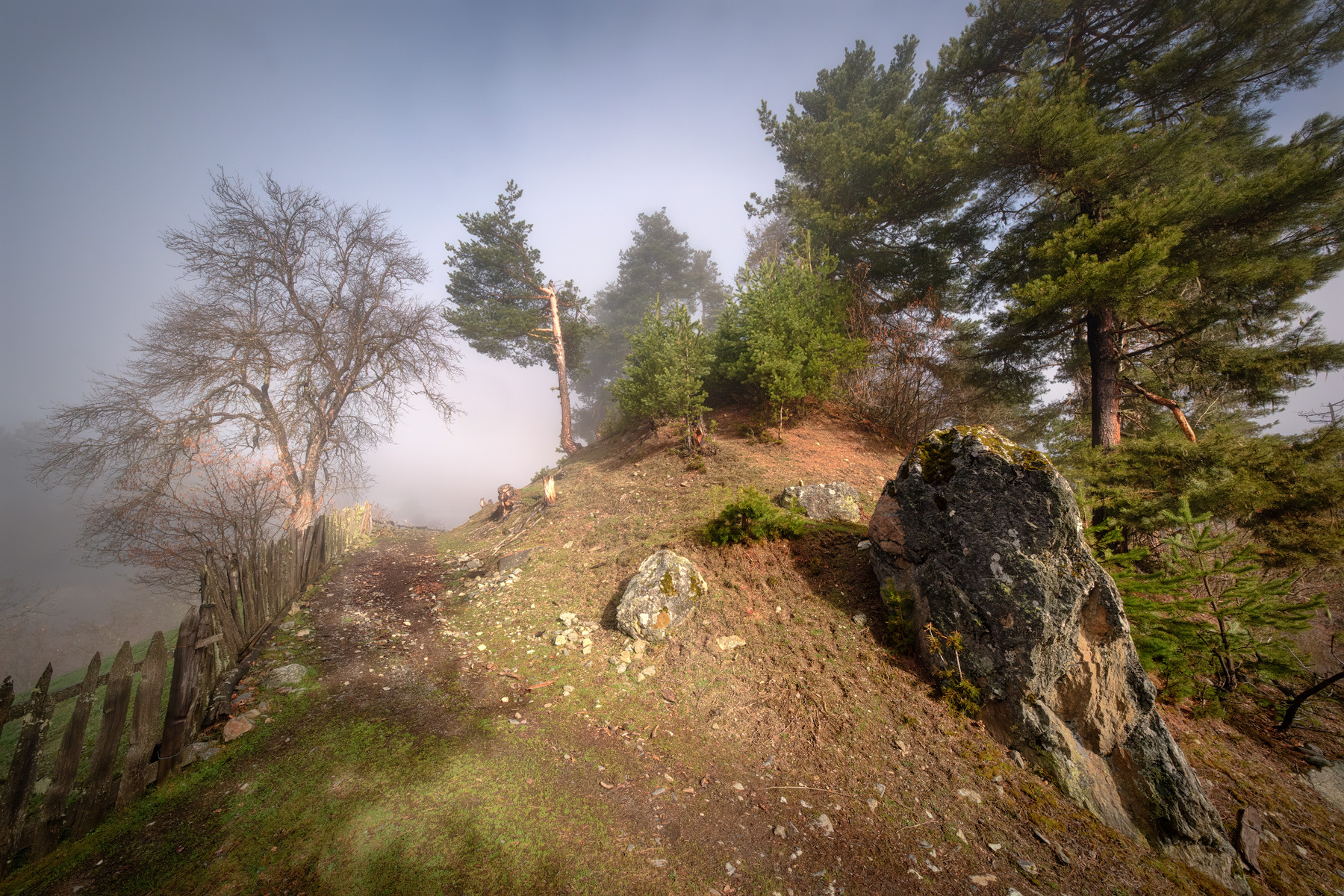 Tsvirmi In Spring svaneti tsvirmi spring clouds fence trees mountains fog sky nature landscape scenery travel outdoors georgia sakartvelo chizh