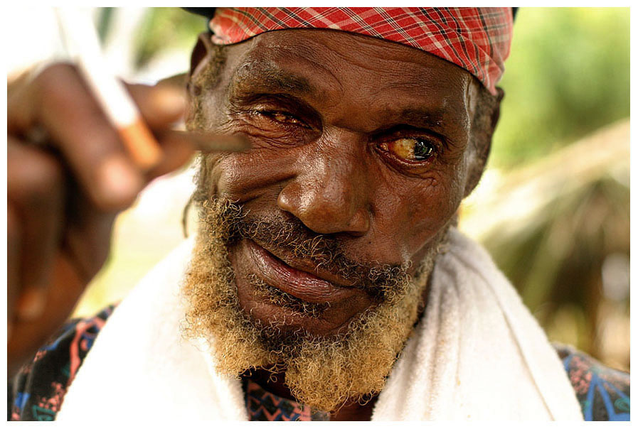 Old rasta-drummer.Jamaica. smoking the grass