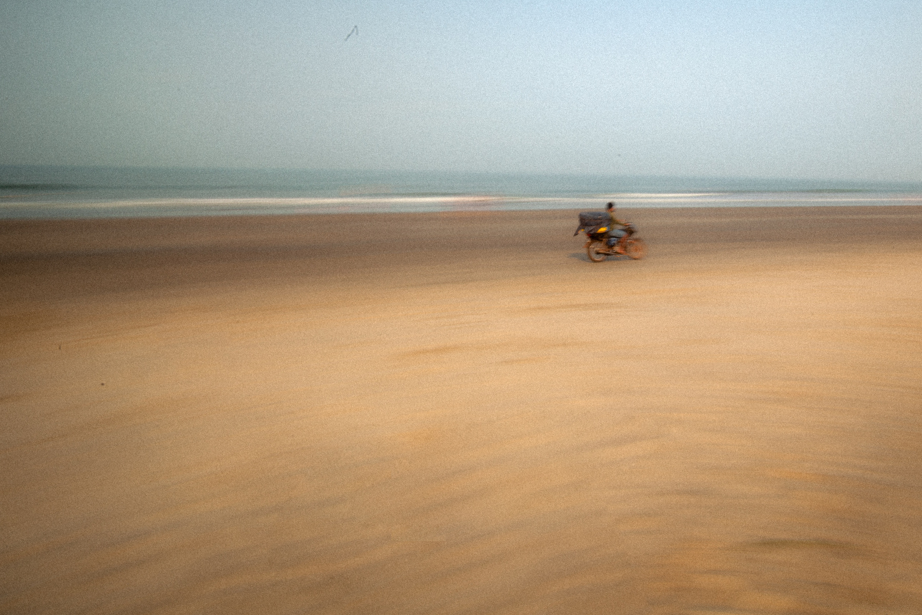 Beach bun beach morning bread seller motorcycle Arambol Goa India street vendor travel local culture seaside sandy sunrise daily life transportation coallaoc arambolsamearambol beachlife