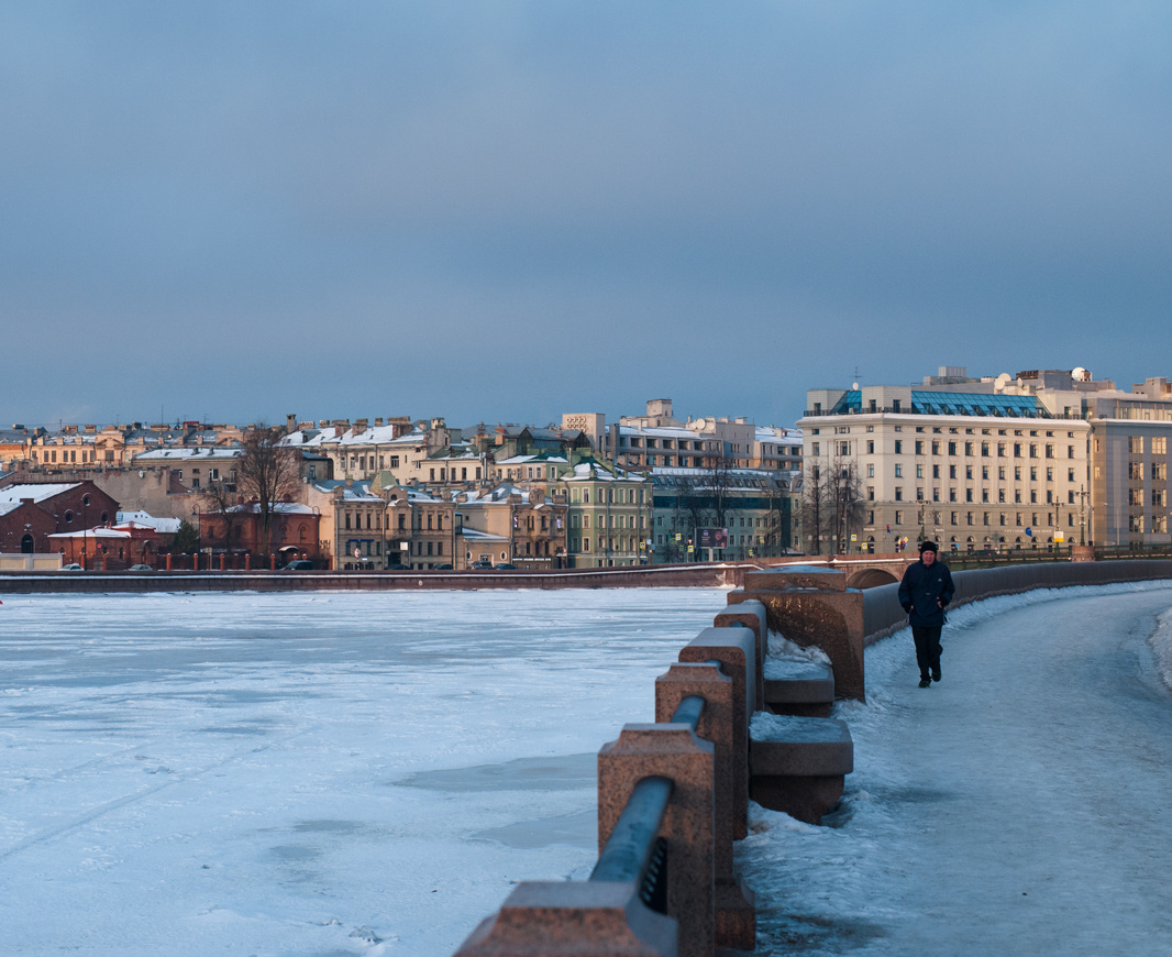 Solitary figure on the bank in morning Petersburg