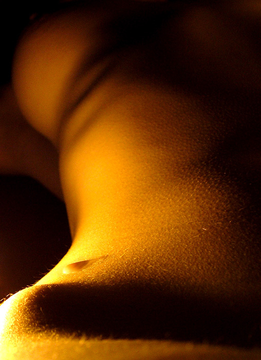 paraffin`s drop candle lighted woman`s body